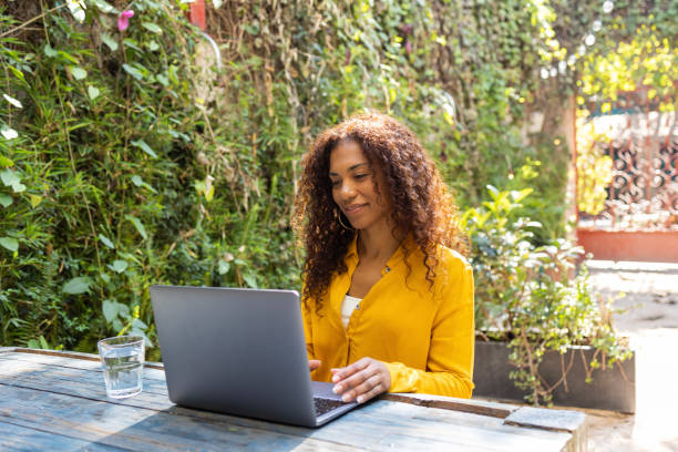 istock Brazilian woman using laptop at garden 2190746547