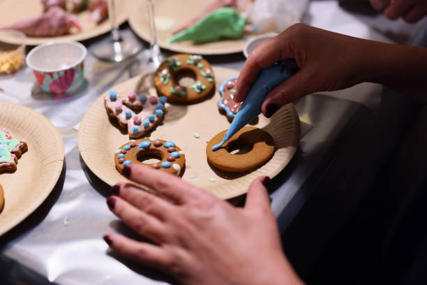 istock Decorating Festive Cookies by Adding Icing and Colorful Sprinkles for Everyone to Enjoy 2190747016