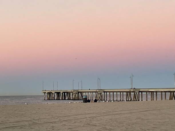 istock The beach and pier with blue pink orange sky. 2190748876