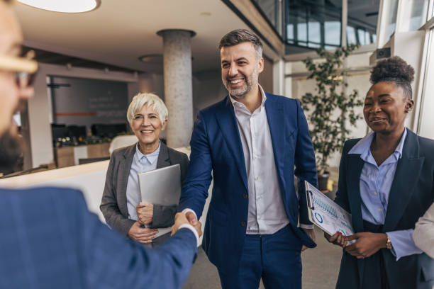 istock Business colleagues congratulate colleague in modern office 2190748983
