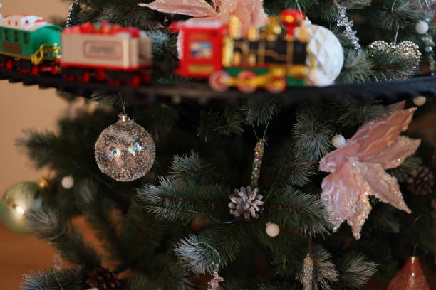 istock A beautifully festive Christmas Tree adorned with a Colorful Train and delightful Ornaments 2190753089