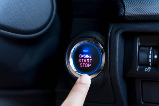 istock The driver palm as it presses the electric car engine start stop button with a blue light illuminated 2190753257