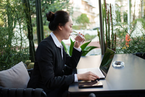 istock Asian business woman drinking water 2190753278