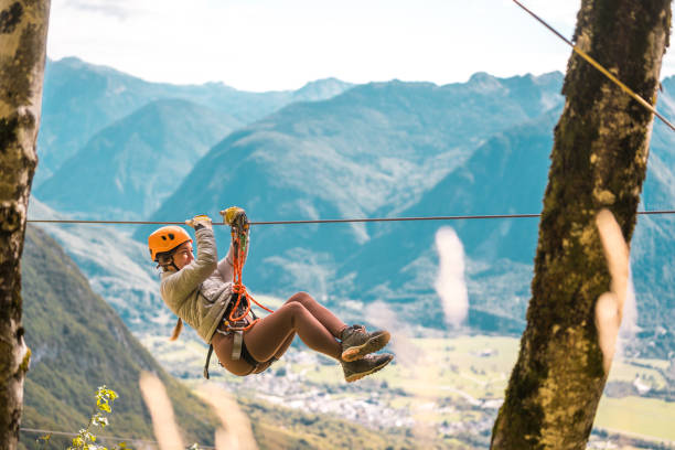 istock Adventurous Female Zip Lining over Scenic Valley 2190760459