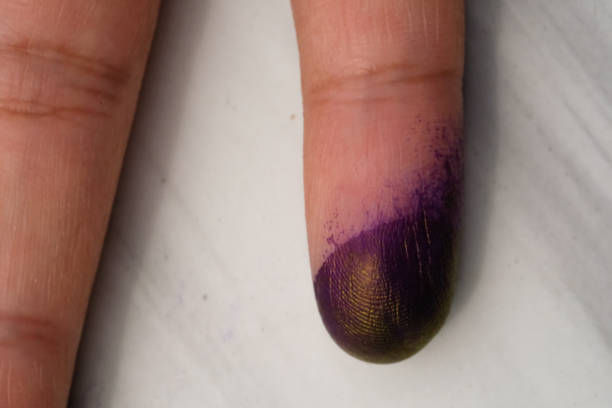 Macrophotography of finger exposed to blue ink. Isolated on white. Finger exposed to ink while replacing ink cartridge in printer machine. Human body parts.