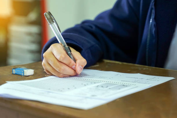 istock Thai students take a knowledge test to assess knowledge skills. The result of the exam will come out as a score value. Allows us to analyze the results or grade. Soft and selective focus. 2190768224