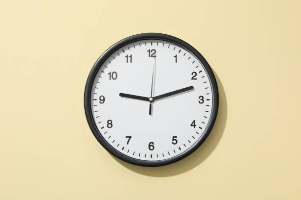 istock Concept of time change with clock on beige background 2190769681