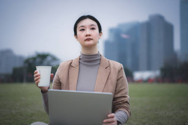 istock Focused Business Woman Enjoying Coffee While Working Outdoors 2190769984