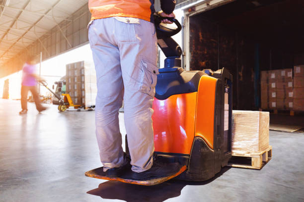 istock Workers Loading Pallets of Goods into The Truck. Forklift Pallet Jack. Package Boxes. Container Shipping. Distribution Warehouse, Supply Chain, Shipment, Freight Truck Logistics Transportation. 2190771168