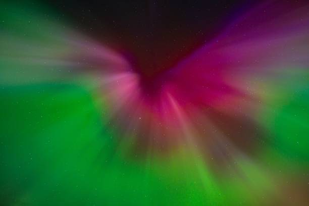 Vibrant aurora borealis with green and purple hues.
