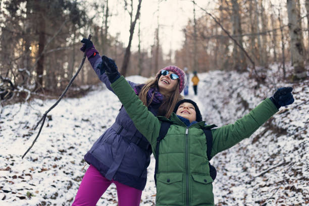 istock Children enjoying hiking in a winter forest 2190773816