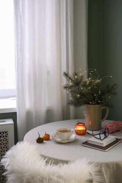 istock A beautifully warm indoor setting that includes delicious green tea, soft candles, and lovely seasonal greenery. Christmas mood. 2190774236