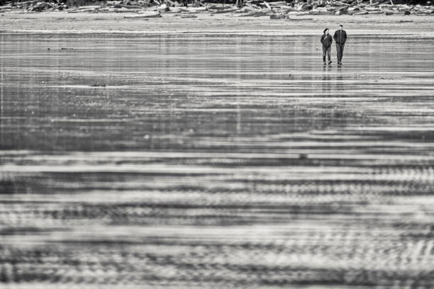 The Pacific Rim National Park in British Columbia on April 23, 2024: Couple walking along the shoreline of Pacific Rim National Park on Vancouver Island, British Columbia