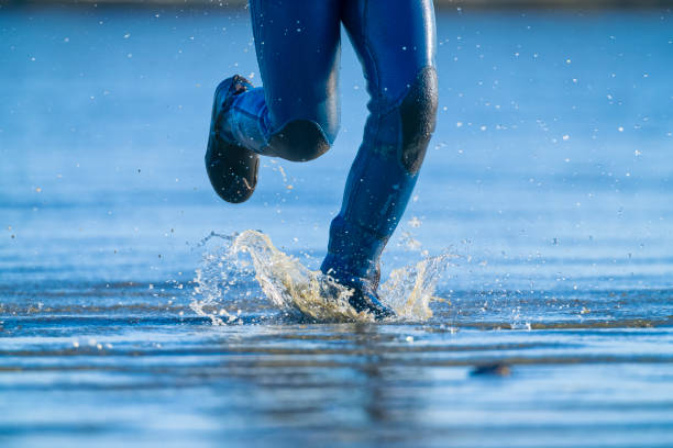 The Pacific Rim National Park in British Columbia on April 30, 2024: Young male surfer returning after a session at Pacific Rim National Park on Vancouver Island, British Columbia