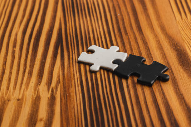 istock puzzle pieces, black and white, concept of unity between opposites 2190776793