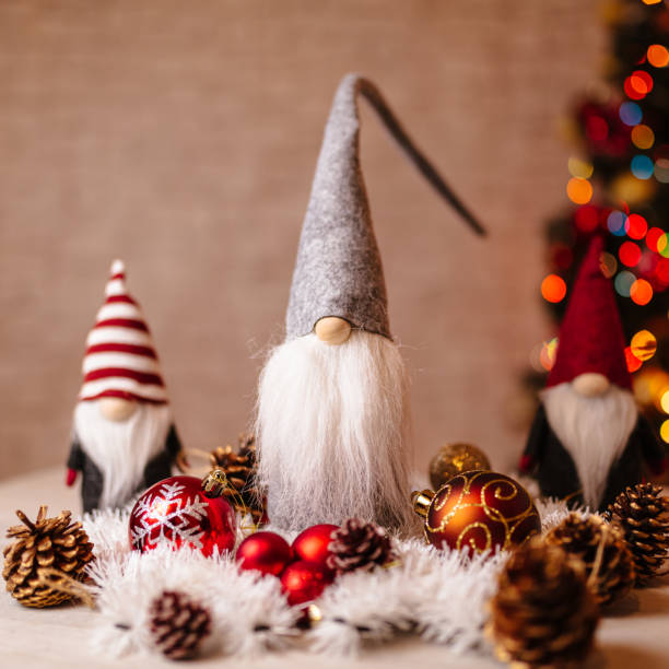 istock Festive Christmas Gnome Decorations with Ornaments and Bokeh Christmas Tree in Background 2190777154