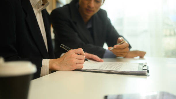 istock Business advisor pointing to a document discussing key details with a client before signing 2190778341