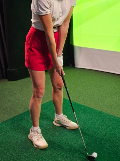 istock Woman practicing golf swing indoors at a virtual golf simulator facility concept 2190778845
