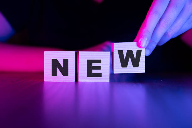 New word with wooden blocks on table