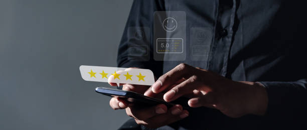 istock Customer Review, Young Man hand using smartphone mobile with five star to review and give 5 stars with very good results in service, Good review 5 star rating choice feedback 2190781365