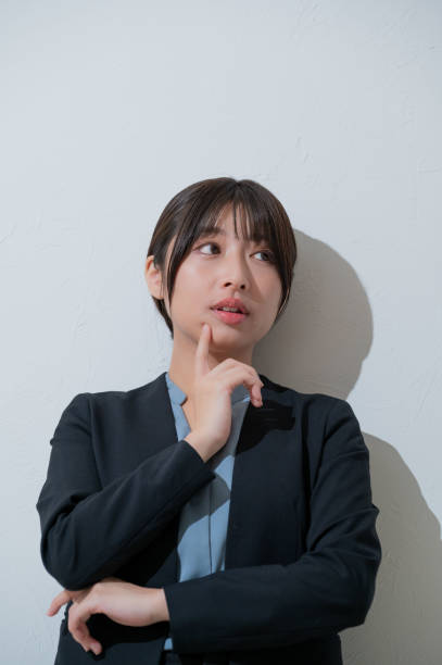 istock A Japanese woman thinking on a white background 2190782952