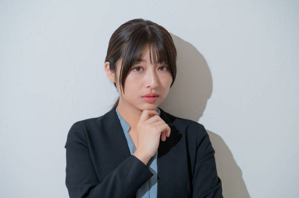 istock A Japanese woman thinking on a white background 2190782968