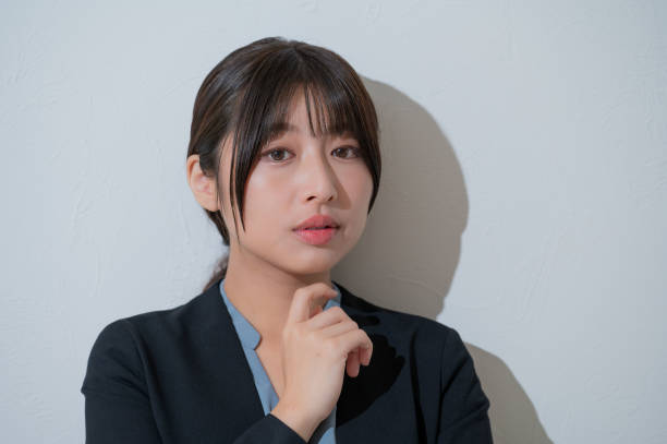 istock A Japanese woman thinking on a white background 2190782970