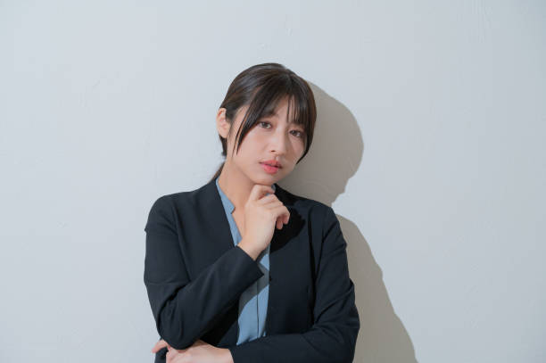 istock A Japanese woman thinking on a white background 2190782971