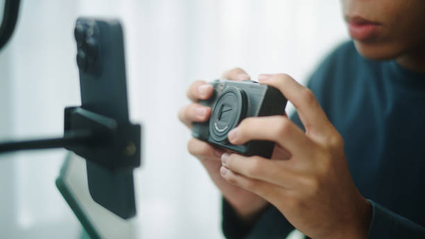 Young asian man blogger or influencer review how to using a camera photo.