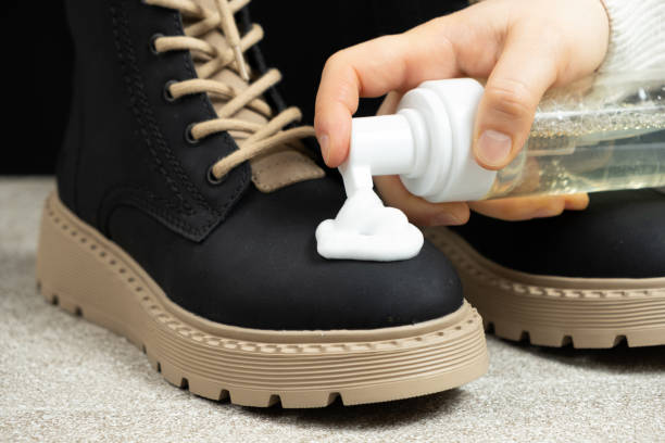 istock Shoe care, applying cleaning foam to the boot 2190785940