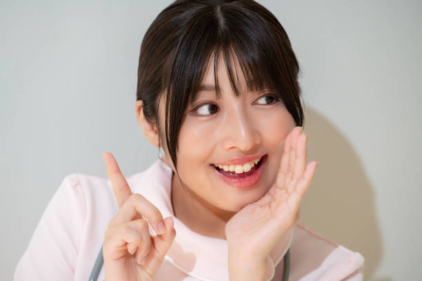 istock Japanese clinic staff whispering on a white background 2190788146