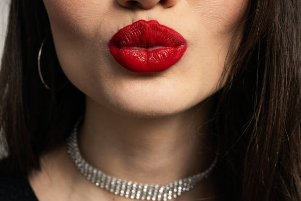 Close-up kiss, female lips with red lipstick