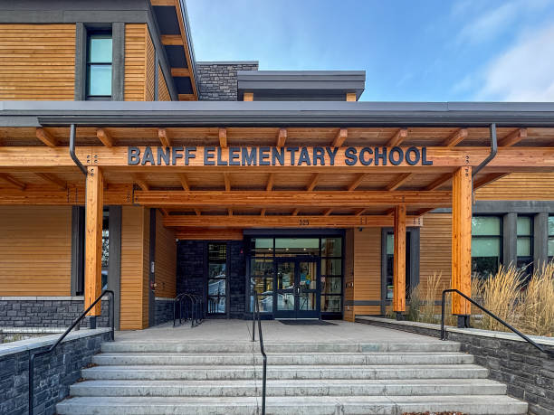 Banff, Alberta, Canada. Dec 18, 2024. Banff Elementary School welcomes students with its inviting entrance, featuring wood accents and a prominent school name.