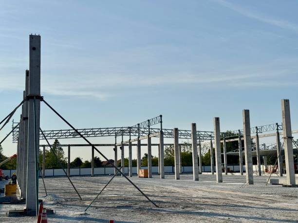 istock Concrete Pillars Reaching for the Sky: A low-angle shot captures the raw power and potential of construction, as concrete pillars rise against a vibrant blue sky, symbolizing progress, resilience. 2190793119
