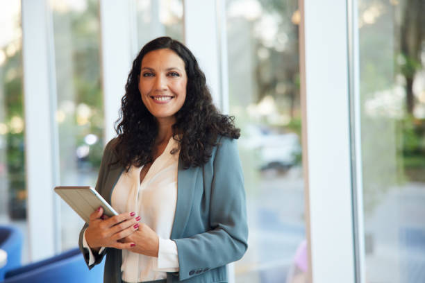istock A businesswoman's portrait captures her looking confidently at the camera in an office setting. 2190793996