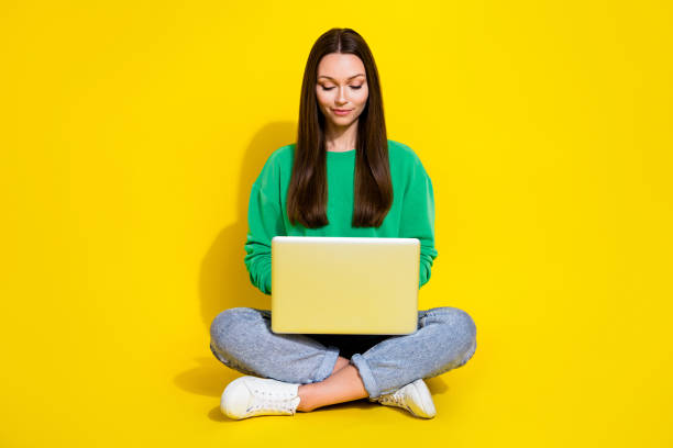 istock Full length photo of pretty young lady netbook create new software coder wear stylish green sportswear isolated on yellow color background 2190794201