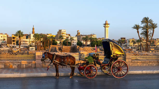 Luxor, Egypt, April 15, 2023: A carriage awaits a customer on the banks of the Nile River in Luxor at sunset.