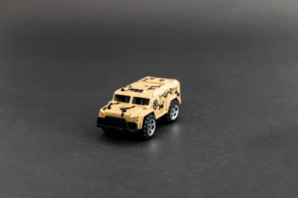 istock Tan Military Armored Vehicle Model on Black Background 2190797350