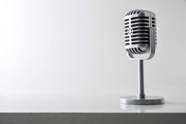 istock Background with vintage microphone on white table and isolated background 2190797548