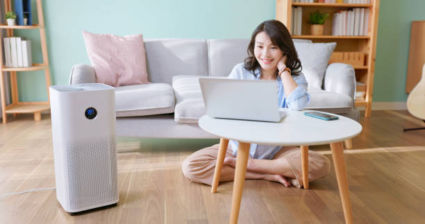 istock woman use air purifier home 2190803375