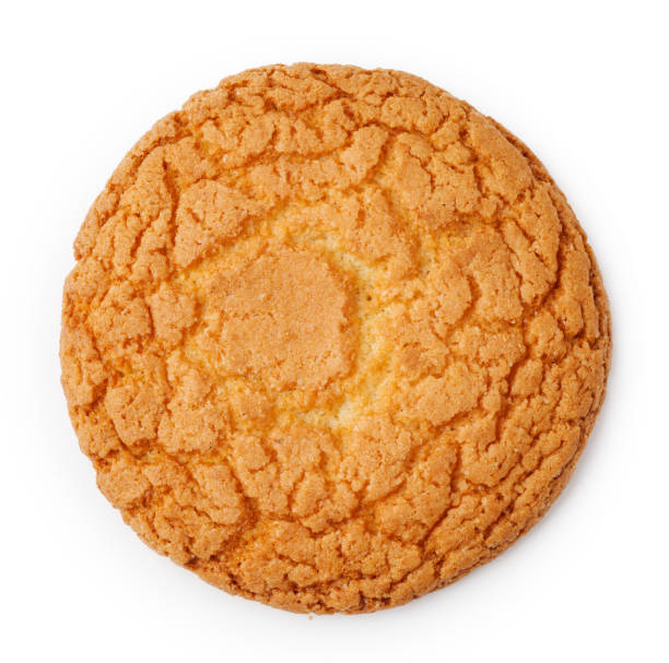 istock Golden brown round cookie with a textured surface sitting on a clean white background during daylight 2190803552