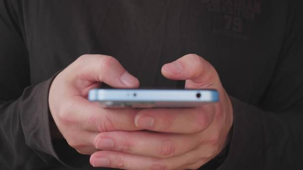 istock A Person Engaging with a Smartphone, with Focused Hands, Demonstrating Modern Connectivity 2190804106
