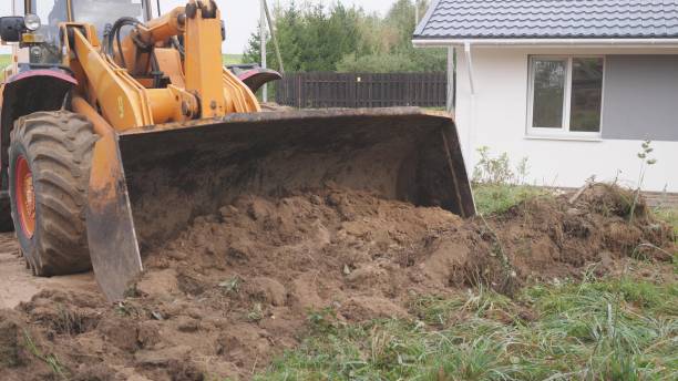istock Heavy machinery performing the task of digging soil at a construction site location 2190805019