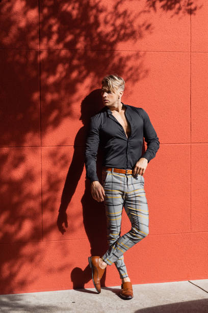 istock Handsome man showcases modern style against a vibrant urban backdrop 2190805118