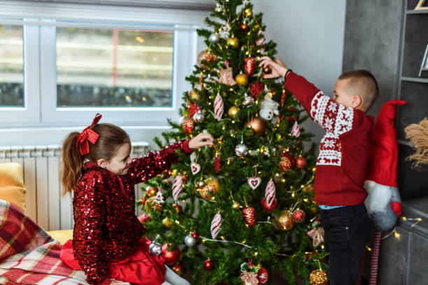 istock Brother and Sister Bonding With Fun Activity of Decorating Christmas Tree 2190805227