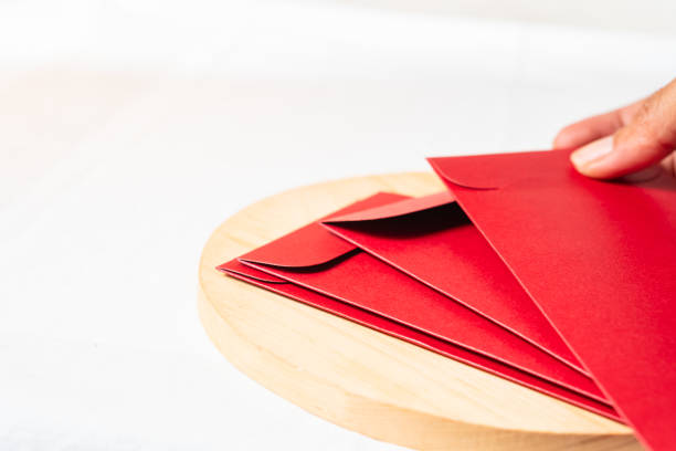 istock Festive Red Envelopes on Wooden Platter 2190806375