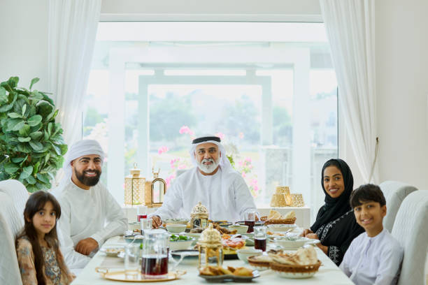 istock Multi-generational Saudi family sitting at dining table 2190807637