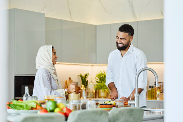 Happy man helping woman in abaya