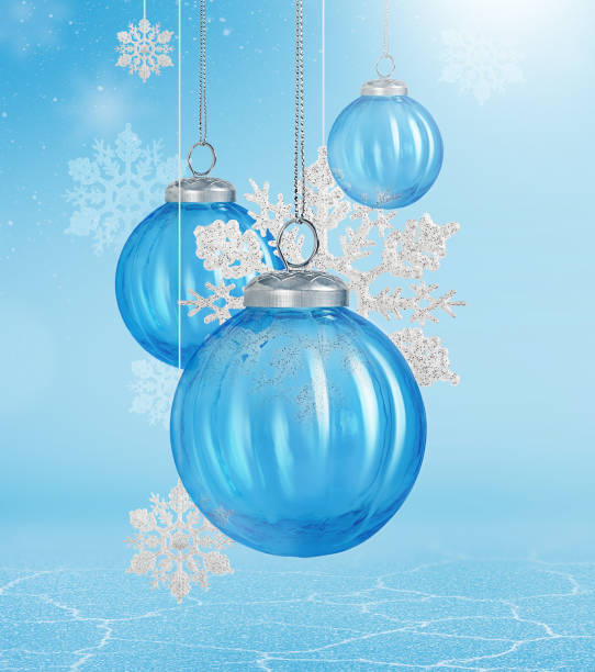 istock Glass blue Christmas tree balls and silver snowflakes on a light blue background with cracked ice surface. 2190808285