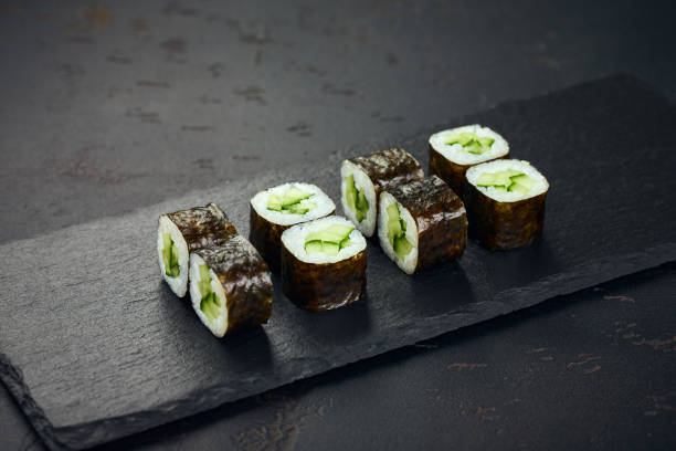 Roll with cucumber on dark background. Sushi menu. Japanese food.